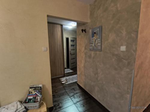 an empty room with a hallway with a wall at Apartament U Anny in Karpacz