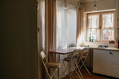 a kitchen with a table and chairs and a window at Stone House in Tîrgu Secuiesc
