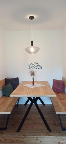 a wooden table in a living room with a lamp at Ferienwohnung Naturblick in Bad Mitterndorf