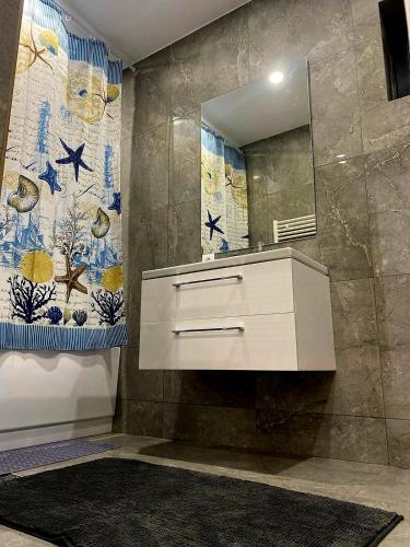 a bathroom with a white sink and a mirror at Cosy Vibe 2 in Vaslui