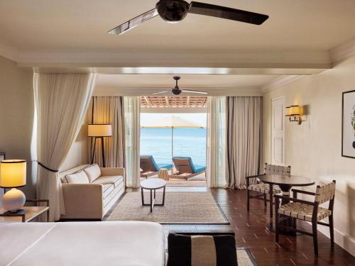 a hotel room with a bed and a view of the ocean at Fairmont Royal Pavilion Barbados Resort in Saint James