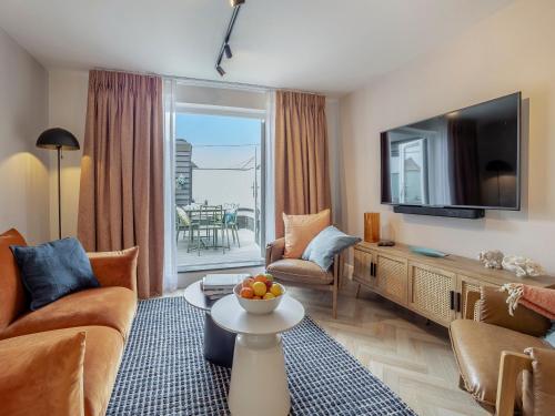 a living room with a couch and a tv at Restharrow - Uk49244 in Whitstable