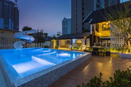 a swimming pool with a water slide in a building at Saga Pool House 5BR, 200m from BEACH in Pattaya North