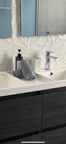 a bathroom with a white sink and a mirror at Mijas Tres Caminos in La Cala de Mijas