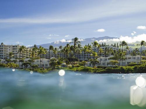 a view of a resort with palm trees and buildings at Fairmont Kea Lani, Maui in Wailea