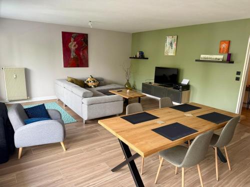 a living room with a table and a couch at The Mandala Room in Thionville