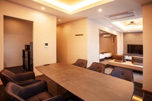 a conference room with a wooden table and chairs at Grand Inn Hakata in Fukuoka