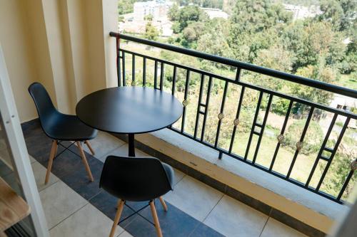 Una mesa y dos sillas en un balcón. en Sunshine Home, en Nanyuki