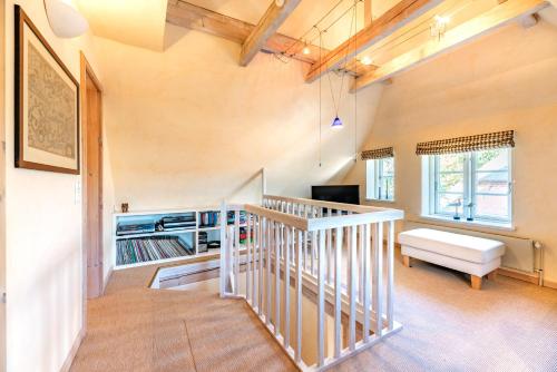 a living room with a staircase and a couch at In Vorbereitung in Oldsum