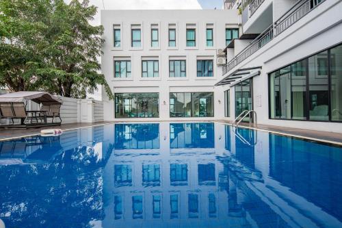 a swimming pool in front of a building at Xinmylin Boutique in North Pattaya
