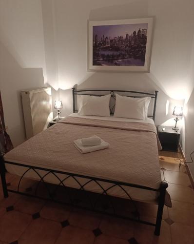 a bedroom with a bed with a towel on it at Anatoli's Apartment in Artemida