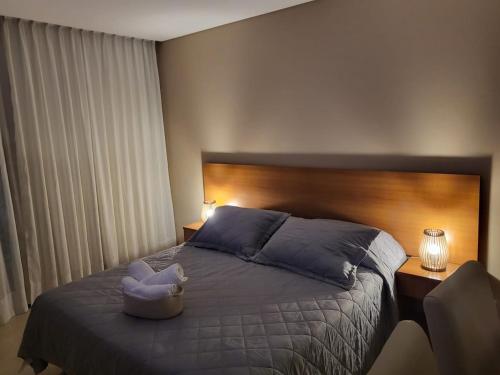 a bedroom with a bed with a stuffed animal on it at Suite Rincon del Sol in Pinamar