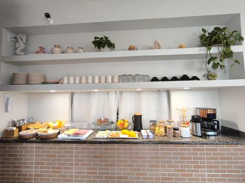 a kitchen counter with a bunch of food on it at Pousada Beira Mar Peruíbe in Peruíbe