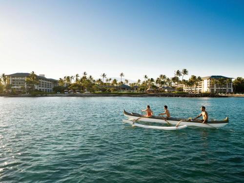 a group of people in a boat on the water at Fairmont Orchid in Waikoloa