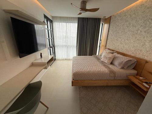 a hotel room with a bed and a television at SYC Hotel Boutique in Arauca