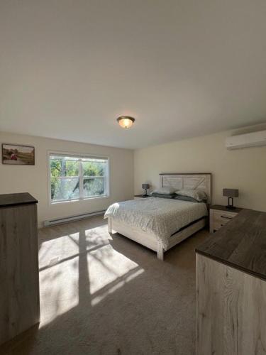 a bedroom with a bed and a large window at Chalet Montelago in The Hideout in Lake Ariel