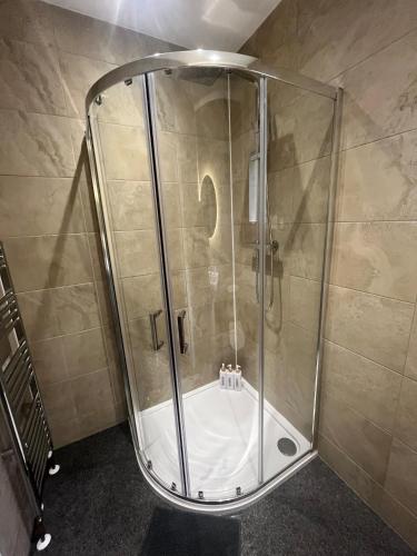 a shower with a glass enclosure in a bathroom at Apartment 288 in Lower Swanwick