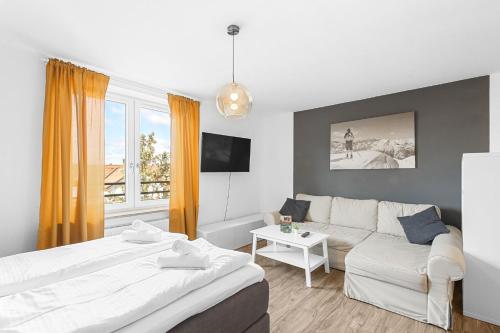 a living room with two beds and a couch at Neben Forum Allgäu inkl. Balkon in Kempten