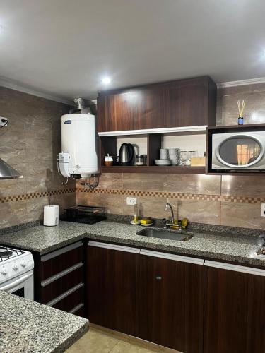 a kitchen with a sink and a counter top at Duplex 2 Villa Ramallo in Estación Ramallo