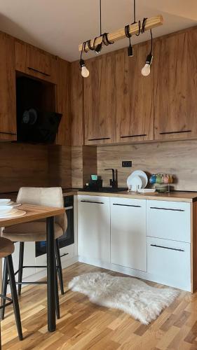 a kitchen with wooden cabinets and a table and a tableablish at DreamerLux in Loznica