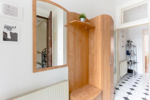a room with a wooden door and a mirror at Central Cosy Stylish Apartment in Vienna