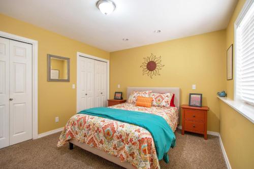 a bedroom with a bed and a yellow wall at Northern Daylights in White Salmon