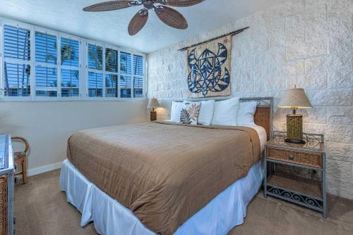 a bedroom with a bed and a ceiling fan at Kanai A Nalu 315 in Wailuku