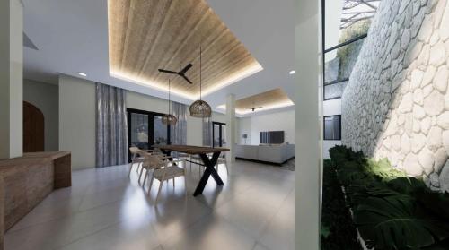 ein Esszimmer mit einem Tisch und Stühlen in einem Haus in der Unterkunft Villa Sensara Sunset Luxury 3BR in Uluwatu