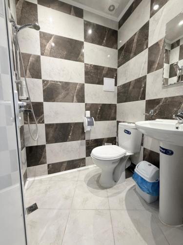 a bathroom with a toilet and a sink at Restaurant-Motel Khan Krum in Kamchiya