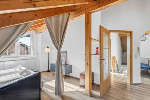 a bedroom with a bed and a living room at Kuschelige Ferienwohnung mit Balkon & Free Wifi in Buchenberg