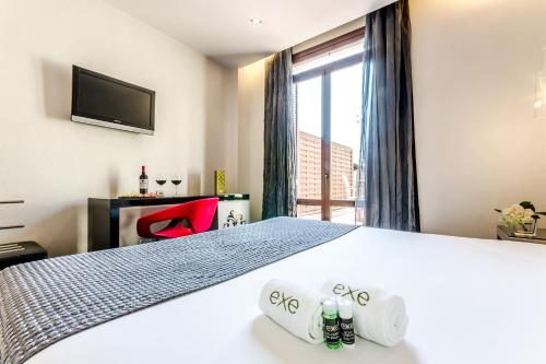 a hotel room with a bed and a window at Exe Ramblas Boquería in Barcelona