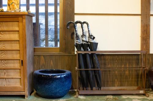 a bunch of umbrellas hanging on a wall at Guest House Maru in Kashima