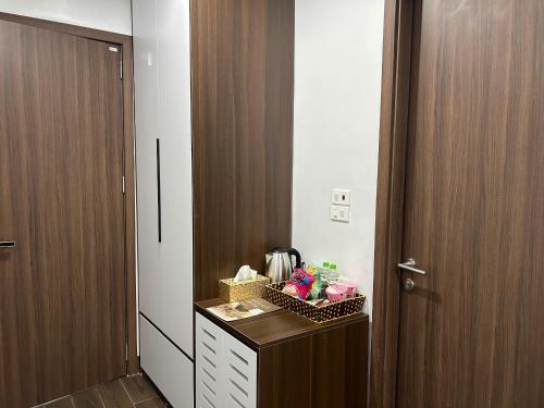 a room with a door and a counter with snacks on it at Elegant Hotel in Hanoi