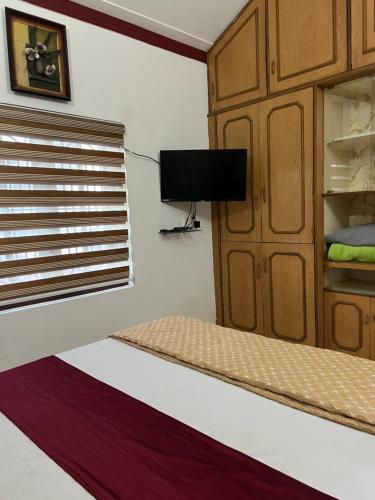 a bedroom with a bunk bed and a tv at House of Raj in Madikeri
