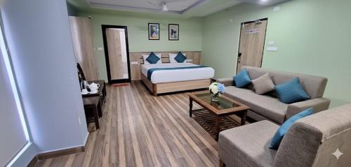 a living room with a bed and a couch at Hotel SVA in Sitam Petta