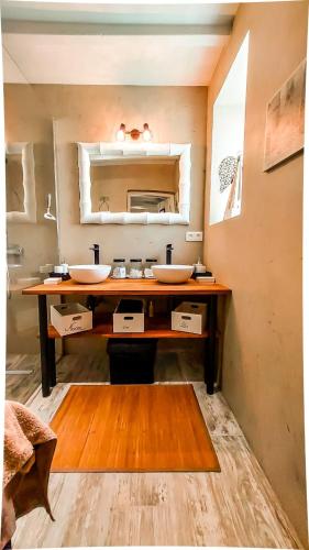 a bathroom with two sinks and a mirror at Maison des îles in Saint Martin