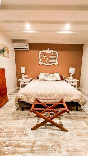 a bedroom with a large bed and two tables at Maison des îles in Saint Martin