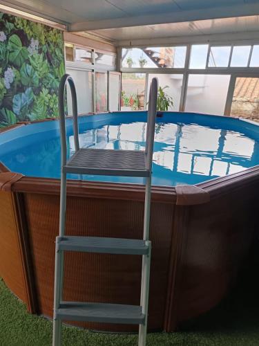 a chair sitting in front of a swimming pool at D'ouro Relax Prestige in Sanfins do Douro