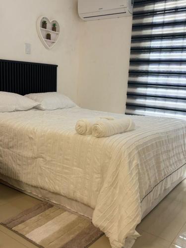 a bed with two towels on it in a bedroom at The Room Veracruz, super location in Veracruz