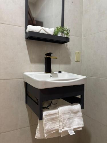 a bathroom with a sink and a mirror and towels at The Room Veracruz, super location in Veracruz