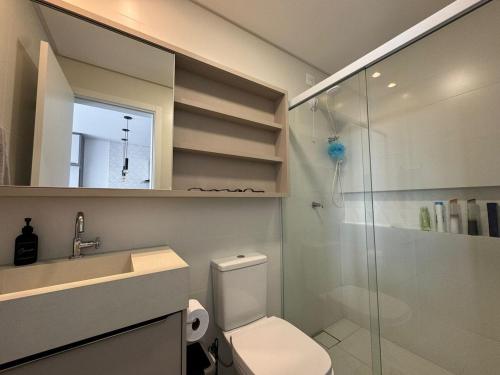 a bathroom with a toilet and a sink and a shower at New Loft in São José