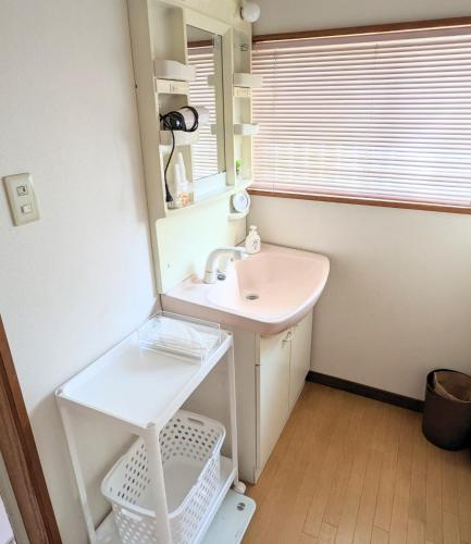 a bathroom with a sink and a mirror at Minpaku ROADHOUSE - Vacation STAY 20160v in Nagasaki