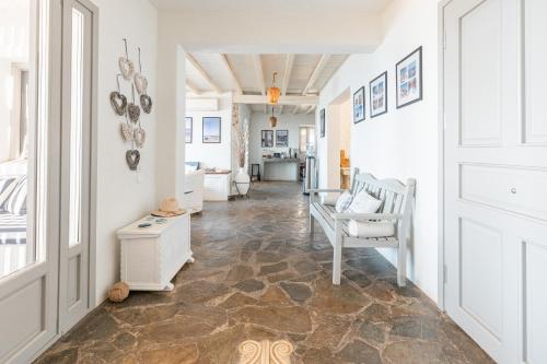 a living room with a hallway with a table and chairs at Villa Néréides in Koundouros