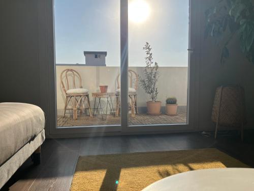 a room with a window with a table and chairs at Modern chic rooftop studio in Sheikh Zayed