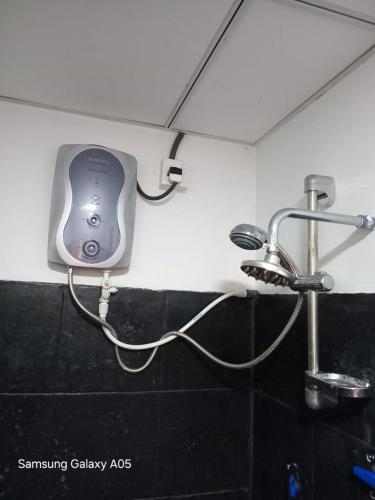 a hair dryer on the wall of a bathroom at Ella Cool Air Cabana in Ella