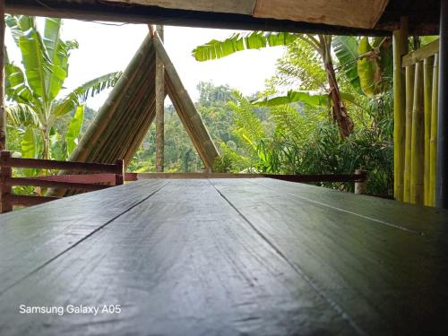a wooden table with a view of a forest at Ella Cool Air Cabana in Ella