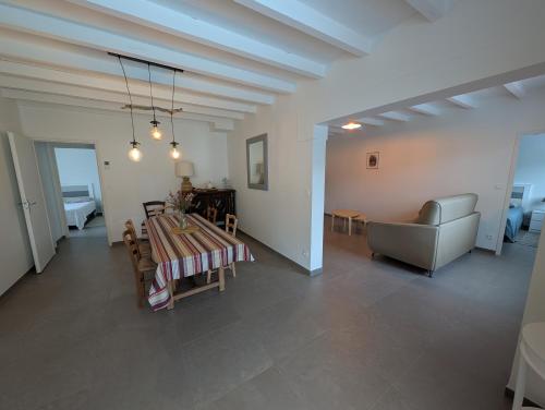 a living room with a table and a chair at Landaise in Messanges