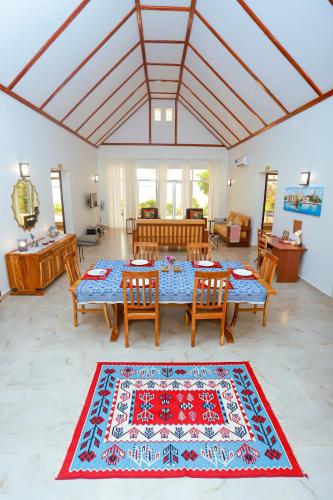 a living room with a table and chairs and a rug at Menai Bay Escape in Mkunguni