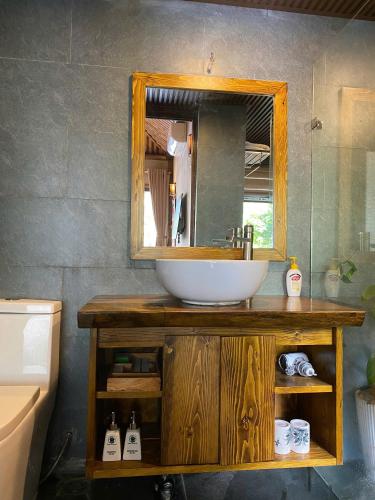 a bathroom with a sink and a mirror at Chapa Ecolodge in Sapa