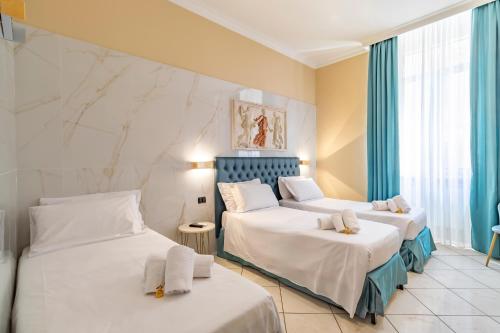 Postel nebo postele na pokoji v ubytování Hotel Suite Caesar